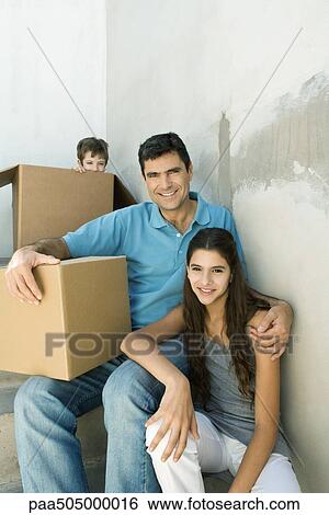 Father and teen daughter on stairwell with cardboard boxes, boy hiding in background View Large Photo Image Stock Photograph - Father and teen daughter on stairwell with cardboard boxes, boy hiding in background. Fotosearch