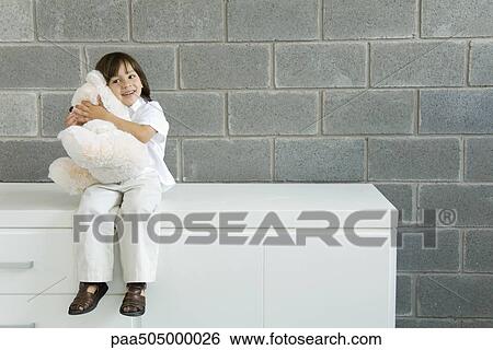 Little boy sitting on counter, hugging teddy bear View Large Photo Image Stock Photograph - Little boy sitting on counter, hugging teddy bear. Fotosearch