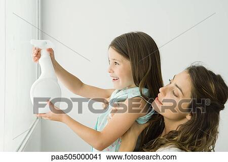 Little girl cleaning window, mother holding her, both smiling View Large Photo Image Stock Image - Little girl cleaning window, mother holding her, both smiling. Fotosearch
