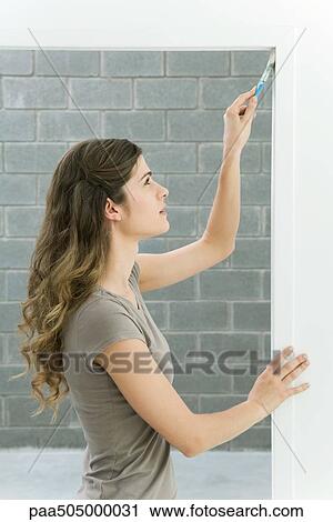 Woman painting doorframe, side view View Large Photo Image Stock Image - Woman painting doorframe, side view. Fotosearch