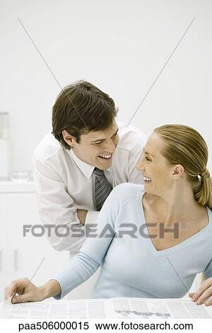 Couple smiling at each other, woman looking back over her shoulder View Large Photo Image Stock Photography - Couple smiling at each other, woman looking back over her shoulder. Fotosearch