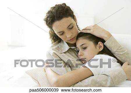 Mother and daughter hugging each other, girl frowning View Large Photo Image Stock Photo - Mother and daughter hugging each other, girl frowning. Fotosearch