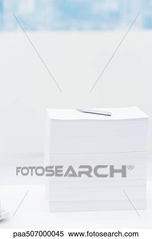 Stack of paper with pen on top of it View Large Photo Image Stock Photography - Stack of paper with pen on top of it. Fotosearch