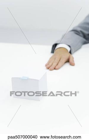 Stack of paper with small adhesive note stuck on it, cropped view of arm nearby View Large Photo Image Stock Image - Stack of paper with small adhesive note stuck on it, cropped view of arm nearby. Fotosearch