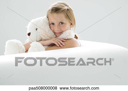 Girl holding teddy bear, smiling at camera View Large Photo Image Stock Photo - Girl holding teddy bear, smiling at camera. Fotosearch