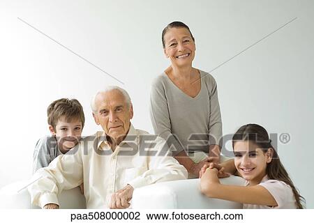 Grandparents sitting with grandchildren, all smiling, portrait View Large Photo Image Stock Image - Grandparents sitting with grandchildren, all smiling, portrait. Fotosearch