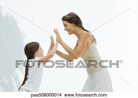 Mother and daughter playing clapping game together View Large Photo Image Picture - Mother and daughter playing clapping game together. Fotosearch