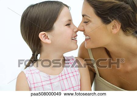 Mother and daughter touching noses, smiling at each other, close-up View Large Photo Image Stock Photo - Mother and daughter touching noses, smiling at each other, close-up. Fotosearch