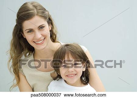 Mother and young son smiling at camera, portrait View Large Photo Image Stock Photo - Mother and young son smiling at camera, portrait. Fotosearch