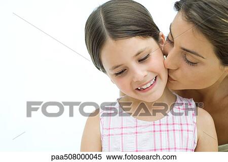 Mother kissing daughter on the cheek, close-up View Large Photo Image Stock Photography - Mother kissing daughter on the cheek, close-up. Fotosearch