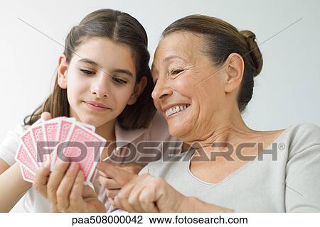 Senior woman and granddaughter playing cards View Large Photo Image Stock Image - Senior woman and granddaughter playing cards. Fotosearch
