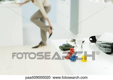 Professional woman getting dressed, focus on baby bottle and toys in foreground View Large Photo Image Stock Image - Professional woman getting dressed, focus on baby bottle and toys in foreground. Fotosearch