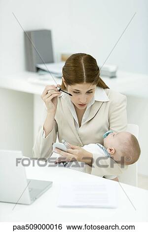 Professional woman in office, applying mascara, holding sleeping baby View Large Photo Image Stock Photograph - Professional woman in office, applying mascara, holding sleeping baby. Fotosearch