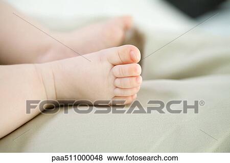 Stock Photo - Infant's bare feet, close-up. Fotosearch