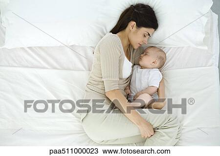 Mother and baby sleeping on bed, overhead view View Large Photo Image Stock Image - Mother and baby sleeping on bed, overhead view. Fotosearch