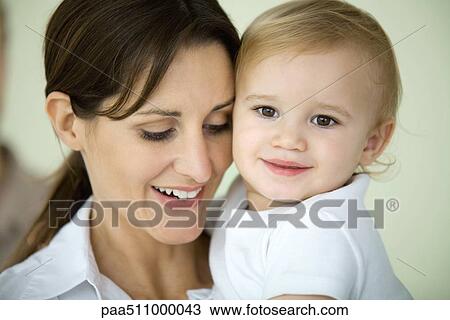 Mother and toddler cheek to cheek, both smiling View Large Photo Image Stock Image - Mother and toddler cheek to cheek, both smiling. Fotosearch