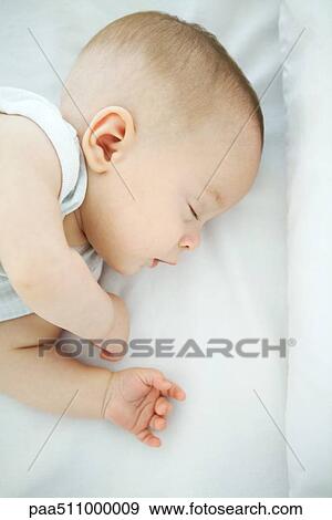 Stock Photo - Sleeping baby, high angle view. Fotosearch