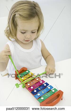 Toddler girl playing xylophone, high angle view View Large Photo Image Stock Image - Toddler girl playing xylophone, high angle view. Fotosearch