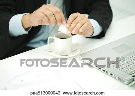 Professional man preparing coffee at desk, cropped view View Large Photo Image Stock Image - Professional man preparing coffee at desk, cropped view. Fotosearch