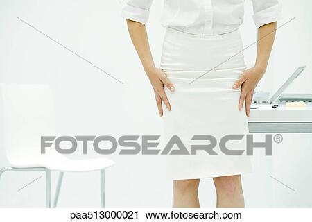 Professional woman in office, adjusting wrinkled skirt, cropped view View Large Photo Image Stock Image - Professional woman in office, adjusting wrinkled skirt, cropped view. Fotosearch