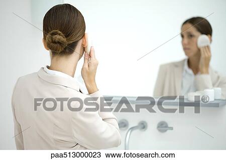 Professional woman powdering face in mirror, rear view View Large Photo Image Stock Image - Professional woman powdering face in mirror, rear view. Fotosearch