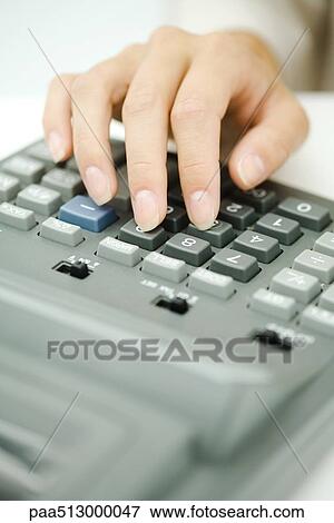 Woman's hand using adding machine, close-up View Large Photo Image Stock Photo - Woman's hand using adding machine, close-up. Fotosearch
