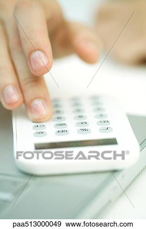 Woman's hand using calculator, extreme close-up View Large Photo Image Stock Photo - Woman's hand using calculator, extreme close-up. Fotosearch