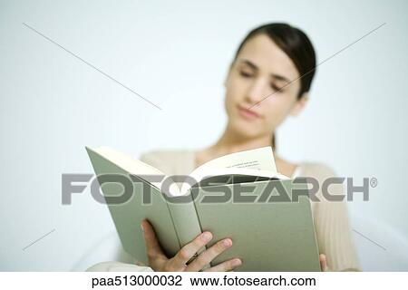 Young woman reading, focus on book in foreground View Large Photo Image Stock Image - Young woman reading, focus on book in foreground. Fotosearch