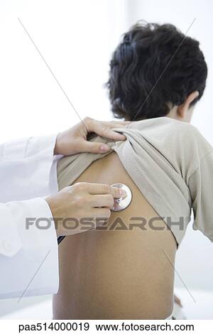 Stock Photo - Doctor placing stethoscope on boy's back, cropped view. Fotosearch