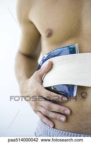 Man holding cold compress against abdomen, cropped view View Large Photo Image Stock Image - Man holding cold compress against abdomen, cropped view. Fotosearch
