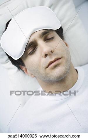 Man reclining with ice pack on his forehead, eyes closed View Large Photo Image Stock Photograph - Man reclining with ice pack on his forehead, eyes closed. Fotosearch