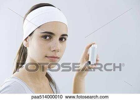 Teen girl holding inhaler, looking at camera View Large Photo Image Stock Image - Teen girl holding inhaler, looking at camera. Fotosearch