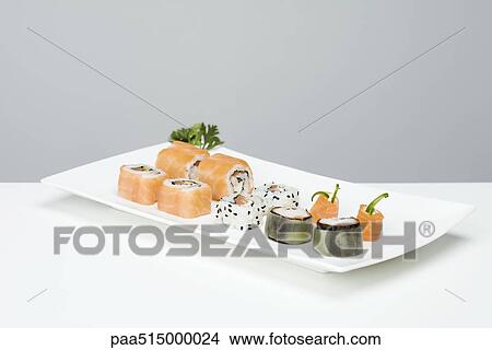Assorted maki sushi arranged on sushi plate View Large Photo Image Picture - Assorted maki sushi arranged on sushi plate. Fotosearch