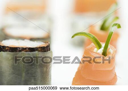 Stock Photo - Cropped view of assorted maki-sushi, close-up. Fotosearch