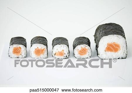 Stock Photo - Five pieces of maki sushi arranged in row, end piece larger than others. Fotosearch