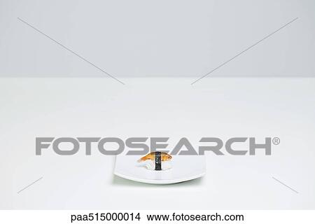 Picture - Goldfish prepared as nigiri sushi placed alone on sushi plate. Fotosearch