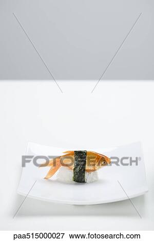 Goldfish prepared as nigiri sushi placed on small sushi plate View Large Photo Image Stock Photo - Goldfish prepared as nigiri sushi placed on small sushi plate. Fotosearch
