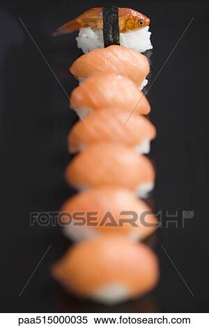 Goldfish prepared as nigiri sushi, placed as end piece of row of salmon nigiri sushi View Large Photo Image Stock Photography - Goldfish prepared as nigiri sushi, placed as end piece of row of salmon nigiri sushi. Fotosearch
