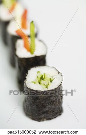 Stock Image - Row of maki sushi, close-up, focus on foreground. Fotosearch