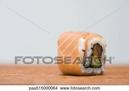 Single piece of salmon maki sushi, close-up View Large Photo Image Picture - Single piece of salmon maki sushi, close-up. Fotosearch