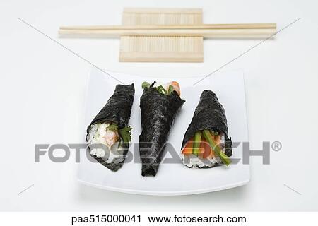 Temaki sushi on sushi plate with chopsticks View Large Photo Image Stock Image - Temaki sushi on sushi plate with chopsticks. Fotosearch