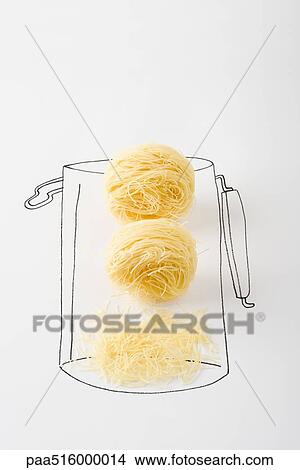 Noodles in canister, broken pieces at the bottom View Large Photo Image Picture - Noodles in canister, broken pieces at the bottom. Fotosearch