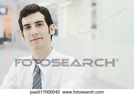 Businessman confidently looking at camera, portrait View Large Photo Image Stock Image - Businessman confidently looking at camera, portrait. Fotosearch