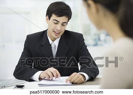 Businessman explaining document to client View Large Photo Image Stock Image - Businessman explaining document to client. Fotosearch