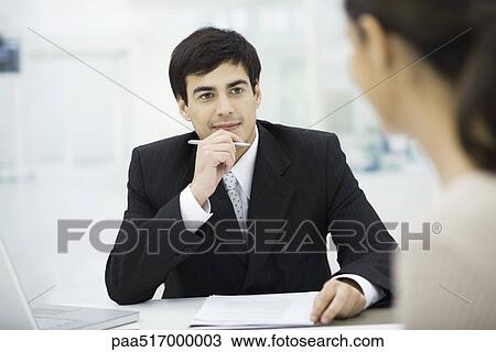 Businessman listening carefully to client View Large Photo Image Stock Image - Businessman listening carefully to client. Fotosearch