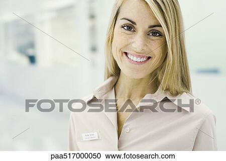 Stock Image - Customer service representative smiling at camera, portrait. Fotosearch