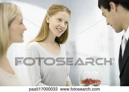 Customer service representatives collecting information from customer, smiling View Large Photo Image Stock Image - Customer service representatives collecting information from customer, smiling. Fotosearch