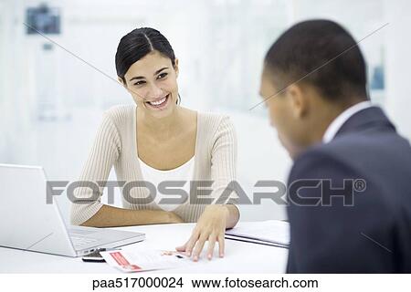 Meeting between professional and client, discussing document View Large Photo Image Picture - Meeting between professional and client, discussing document. Fotosearch