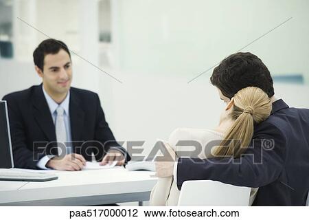 Meeting between professional and clients, woman resting head on man's shoulder View Large Photo Image Stock Image - Meeting between professional and clients, woman resting head on man's shoulder. Fotosearch