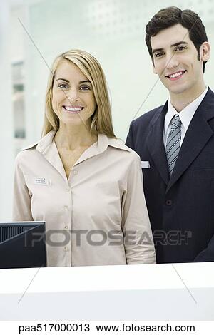 Two professionals smiling at camera, portrait View Large Photo Image Stock Image - Two professionals smiling at camera, portrait. Fotosearch